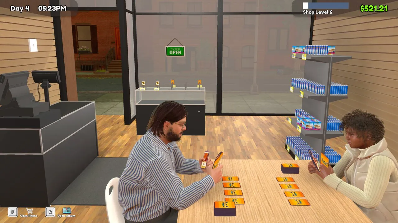 Two players seated across a table playing a Tetramon card duel